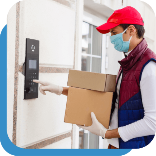 Delivery worker wearing mask and gloves and delivering boxes to client