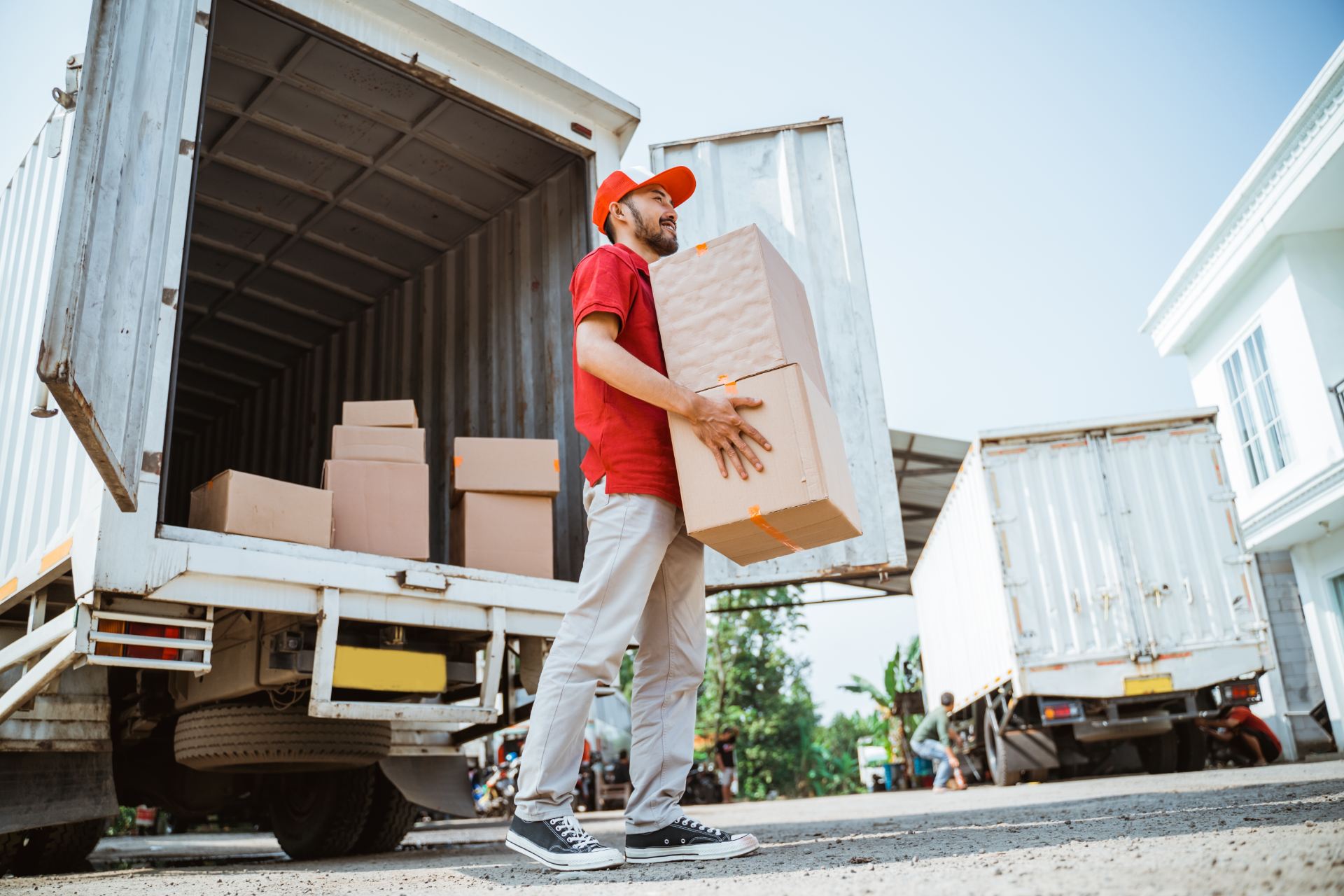 Warehouse worker carrying boxes